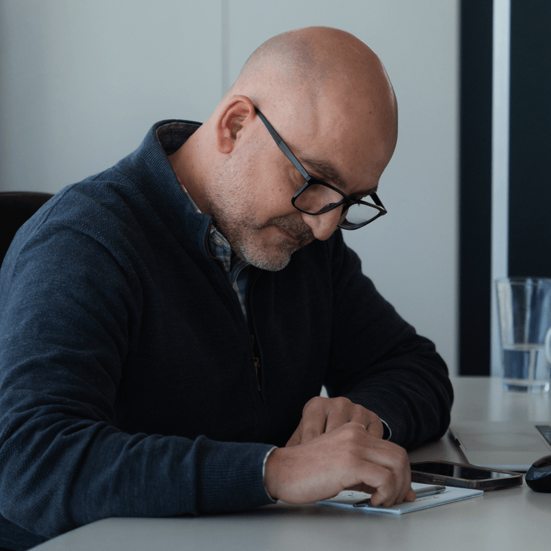 Colleague writing notes at a desk